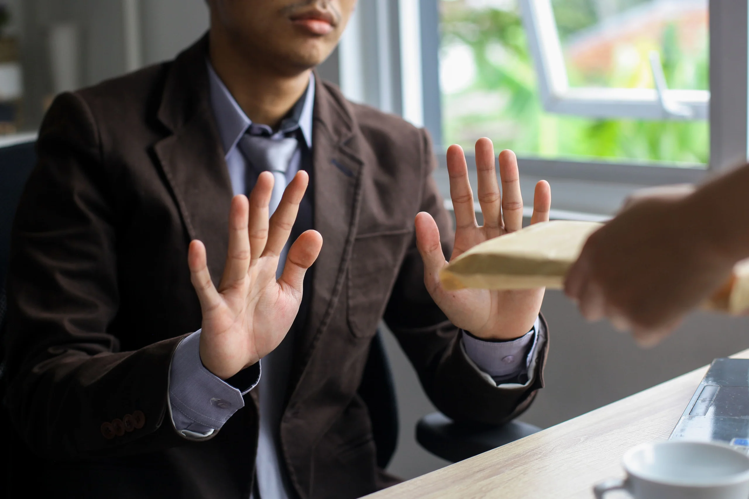 an image representing the blog A man in formal attire clutches a piece of paper, highlighting the issue of employee rights amid misconduct claims.