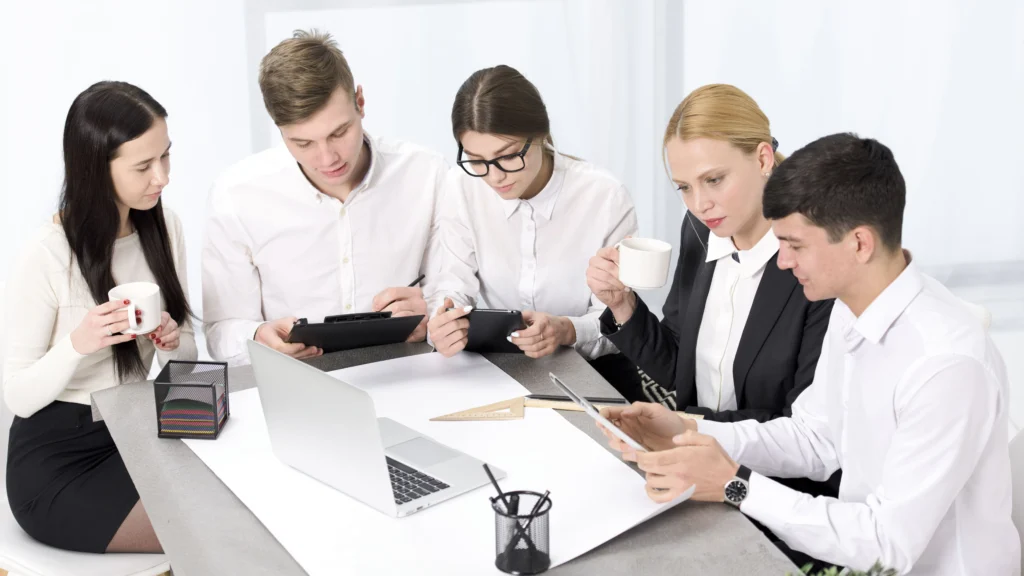 a-group-of-professionals-discussing-a-class-action-lawsuit-around-a-table-with-a-laptop-in-front-of-them-filing-a-class-action-lawsuit-without-proof-in-los-angeles-california