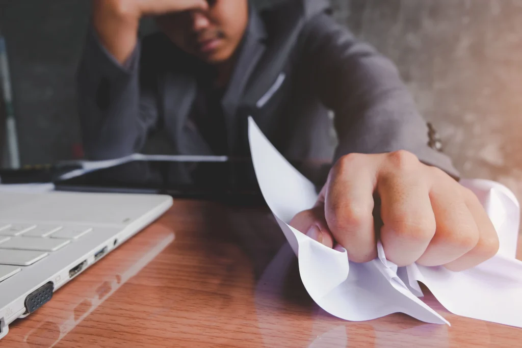 a-person-in-a-suit-holds-a-piece-of-paper-symbolizing-a-document-related-to-unlawful-termination-how-to-win-a-wrongful-termination-case-in-california
