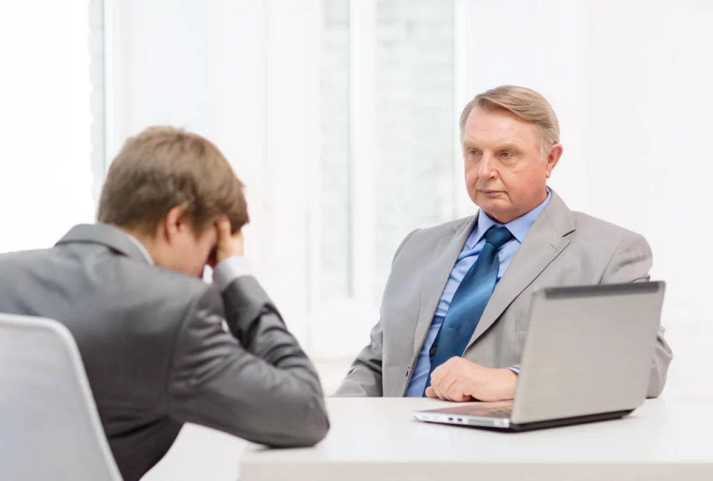 a-suited-man-at-a-table-with-a-laptop-looking-focused-possibly-engaged-in-an-employee-termination-conversation-why-you-need-an-attorney-for-employee-termination-in-los-angeles-california
