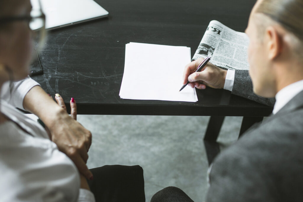 close up two businesspeople doing paperwork
