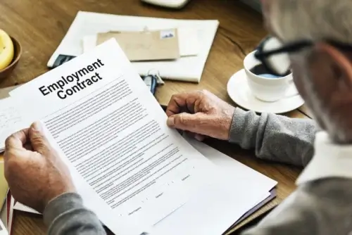 Worker reviewing an employment contract before seeking legal guidance from a Spokane employment law attorney.