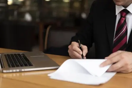 Employment attorney reviewing and signing legal documents related to a workplace dispute for a client in Tacoma, Washington.